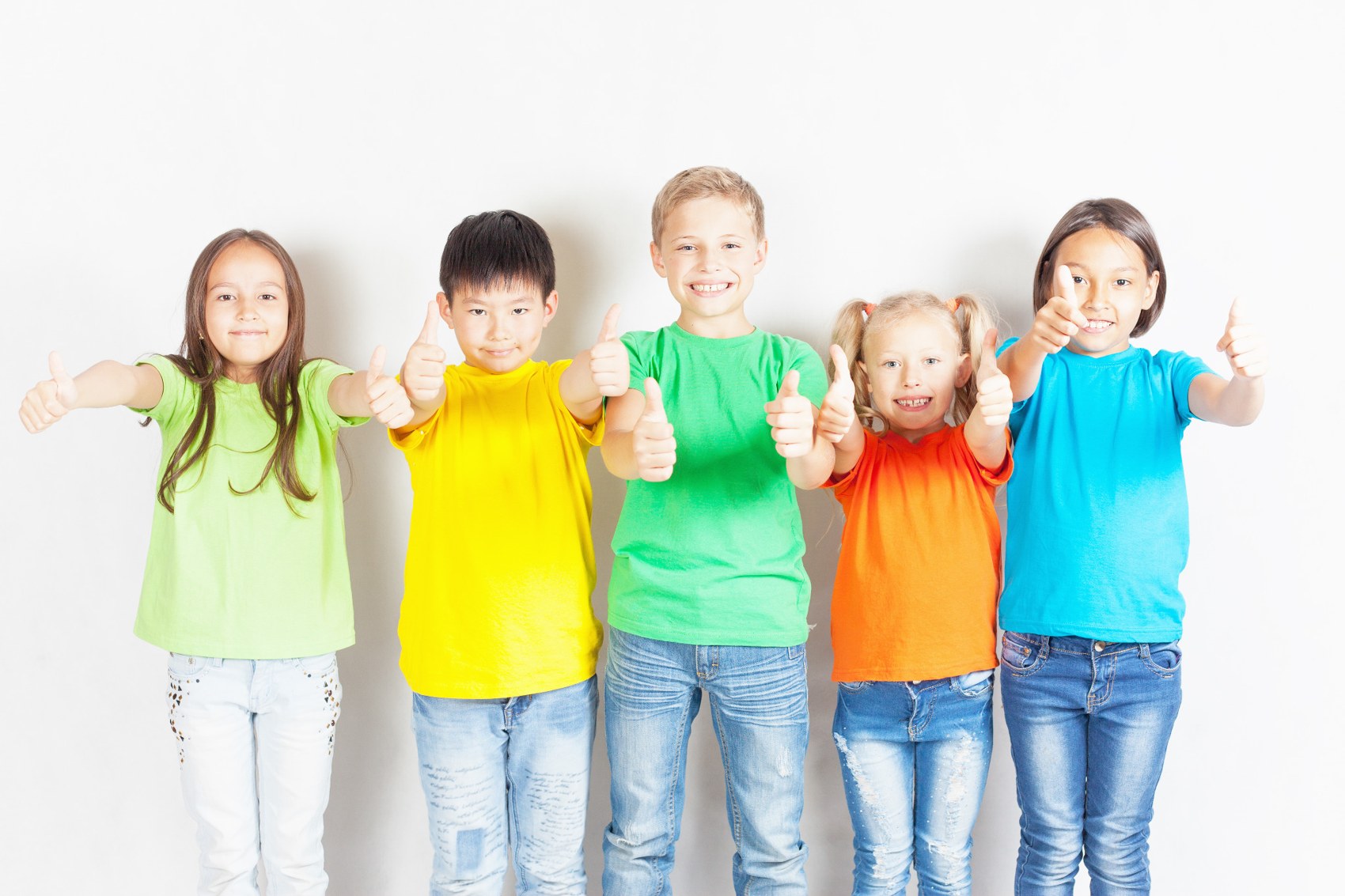 Children standing together and giving thumbs up