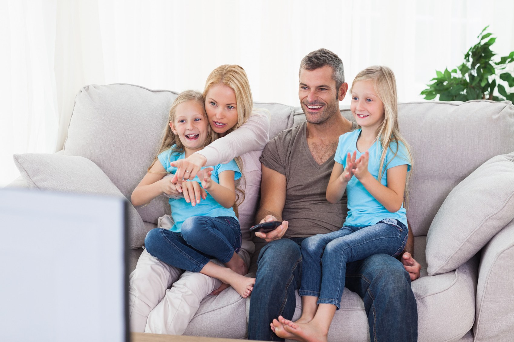 Parents and children spending time together on a sofa
