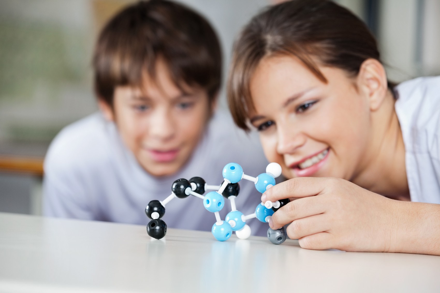 Teacher and student exploring a molecular model
